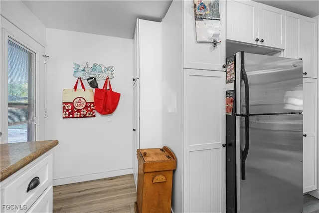 a white refrigerator freezer and a stove sitting inside of a kitchen