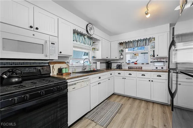 a kitchen with appliances cabinets and a counter top space