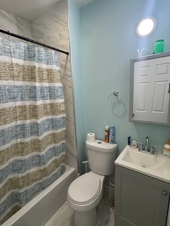 a bathroom with a sink toilet and shower