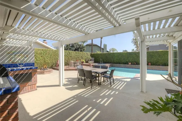 a patio with yard glass top table and chairs