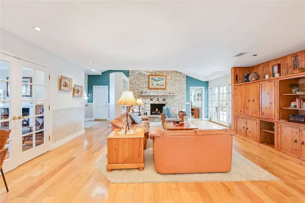 a living room with furniture a flat screen tv and a table