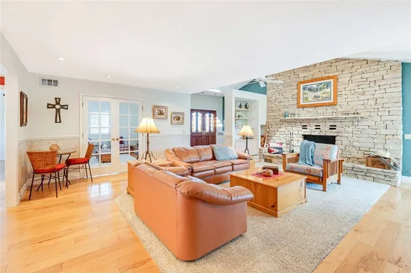 a living room with fireplace furniture and a flat screen tv