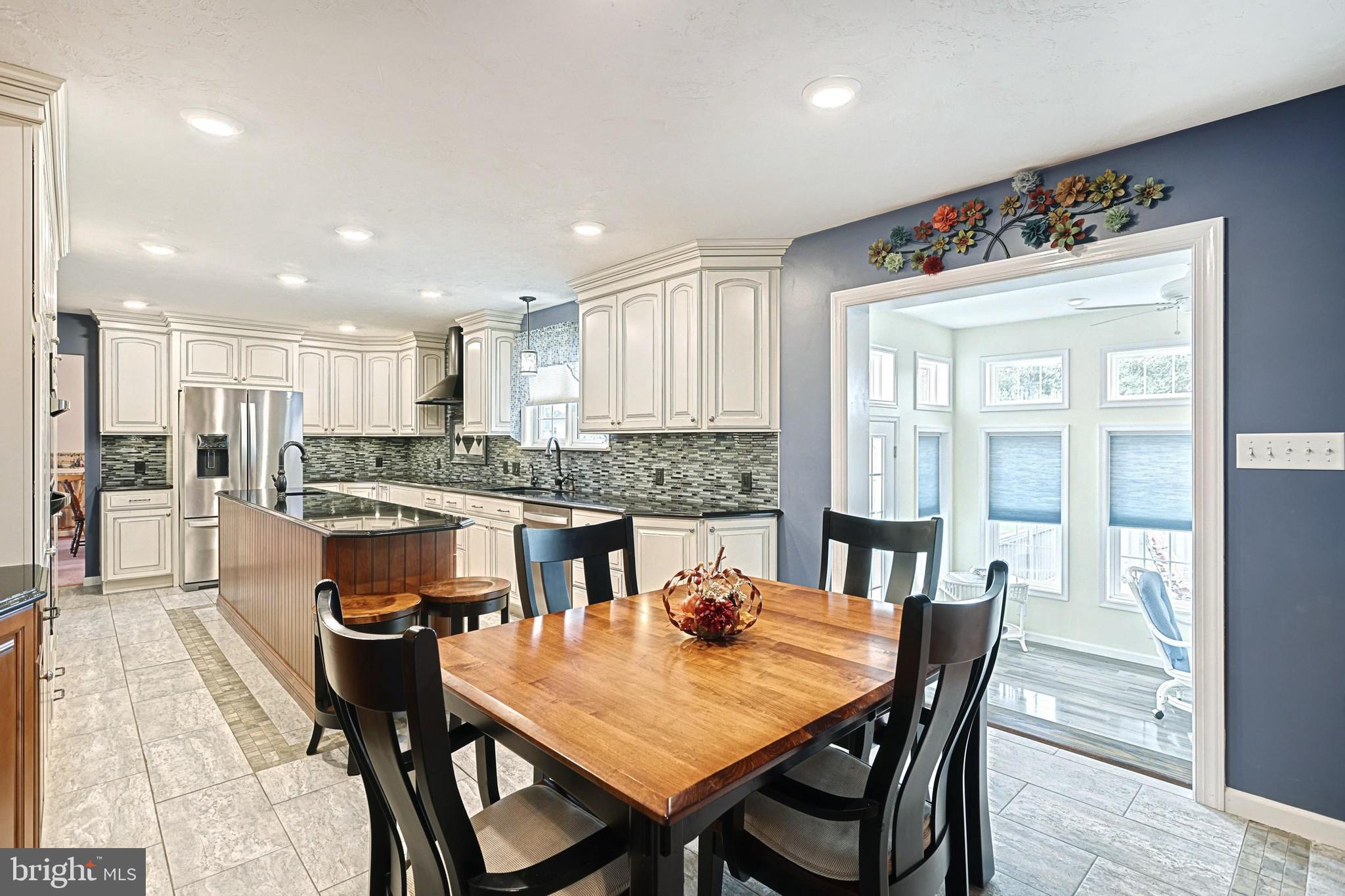 645 Kindig Road Littlestown, PA 17340 - Photo 20 of 61 a kitchen with a dining table chairs and refrigerator