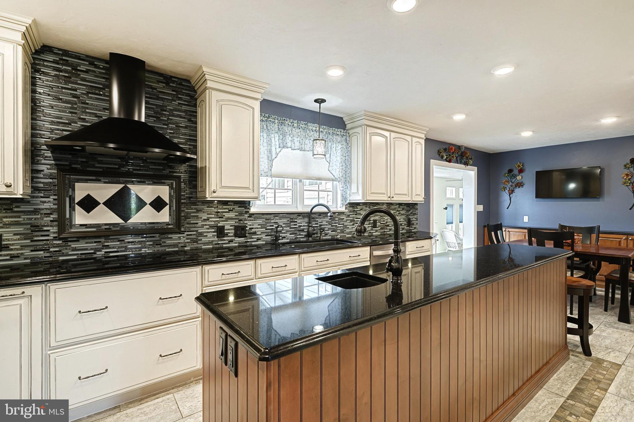 645 Kindig Road Littlestown, PA 17340 - Photo 22 of 61 a kitchen with stainless steel appliances granite countertop a stove a sink and a granite counter tops with white cabinets
