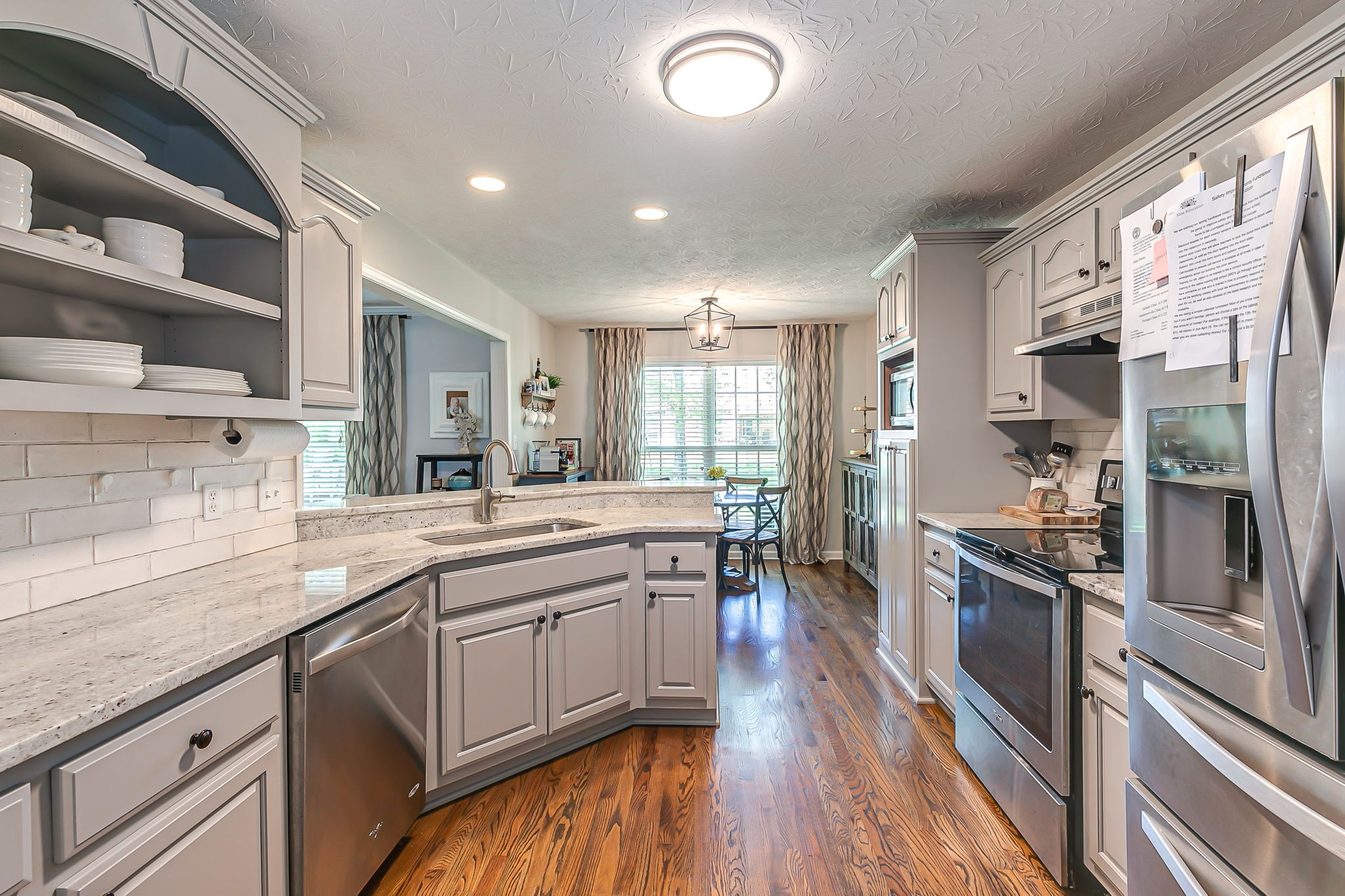 163 Abbey Road Gallatin, TN 37066 - Photo 16 of 39 a kitchen with stainless steel appliances granite countertop a sink and stove top oven
