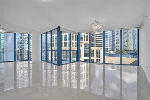 a view of a living room and floor to ceiling window