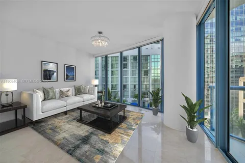 a large living room with stainless steel appliances kitchen island granite countertop furniture and a large window