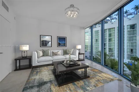 a living room with furniture and floor to ceiling windows