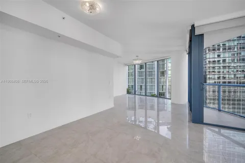 a large room with a bed and a painting on the wall