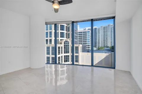 a living room with stainless steel appliances kitchen island granite countertop furniture a rug and a large window