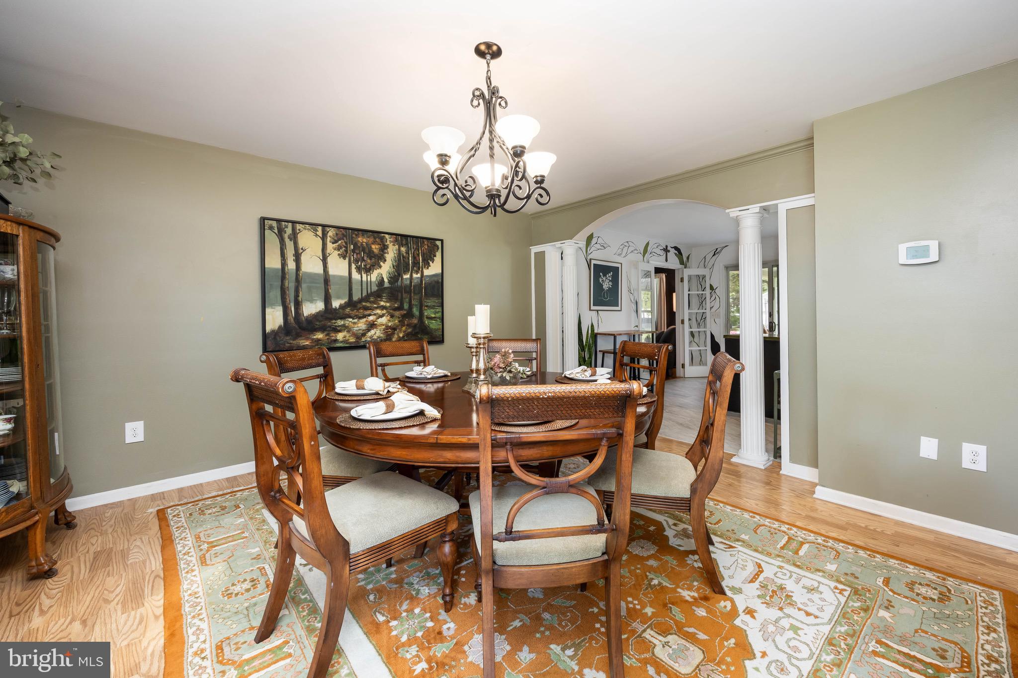 26882 Pratt Road Salisbury, MD 21801 - Photo 12 of 80 a dining room with furniture a chandelier and wooden floor
