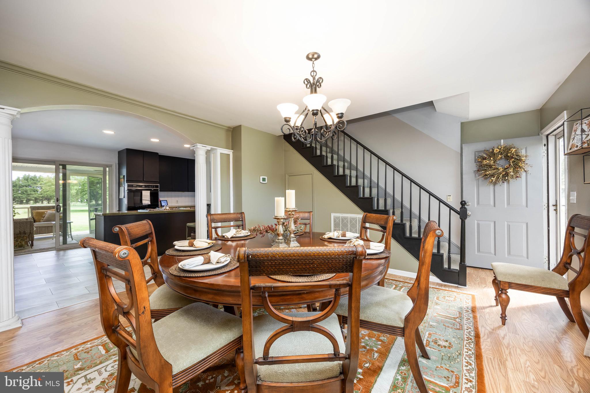 26882 Pratt Road Salisbury, MD 21801 - Photo 13 of 80 a dining room with furniture a chandelier and wooden floor