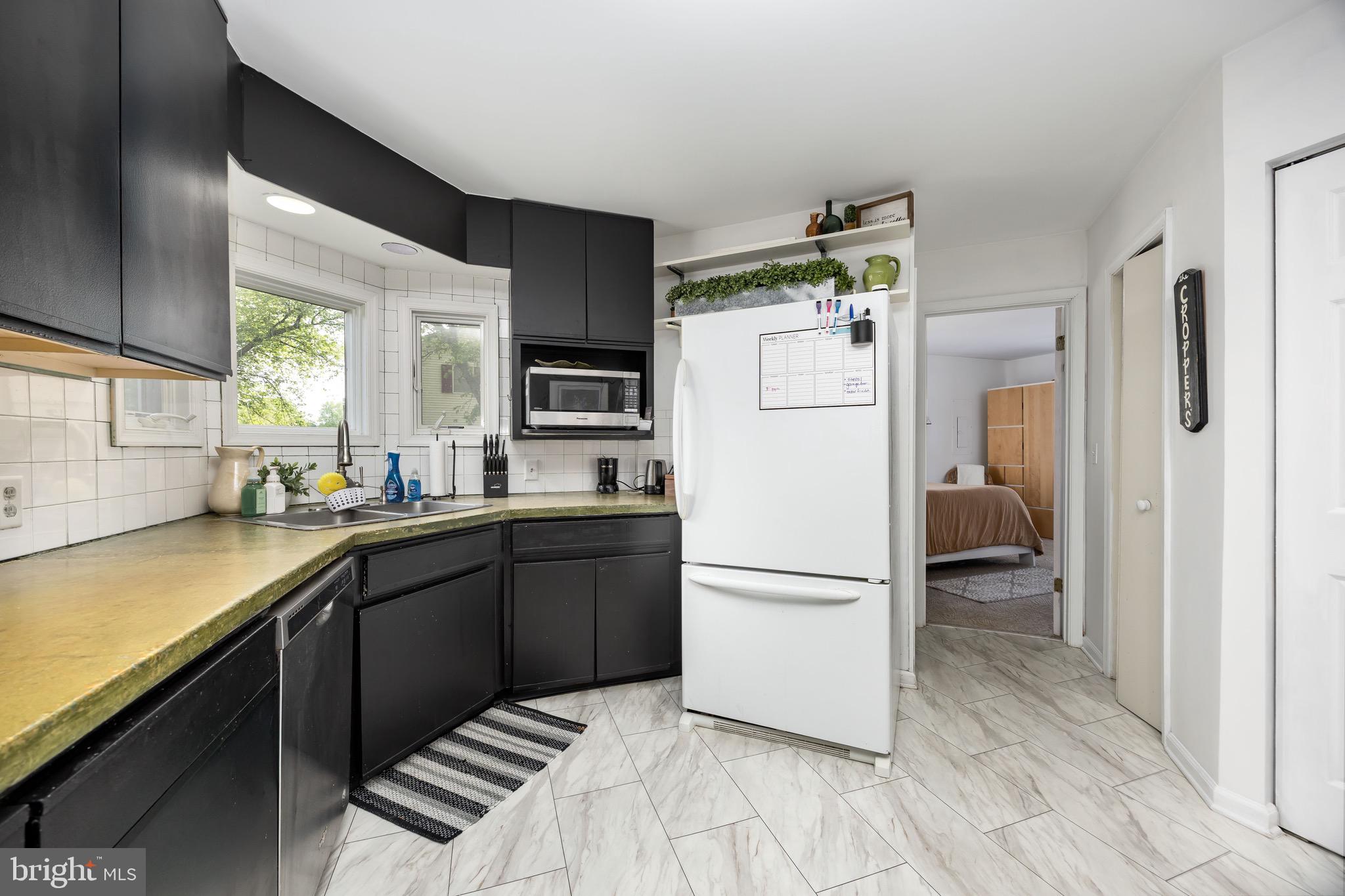 26882 Pratt Road Salisbury, MD 21801 - Photo 19 of 80 a kitchen with a refrigerator and a sink
