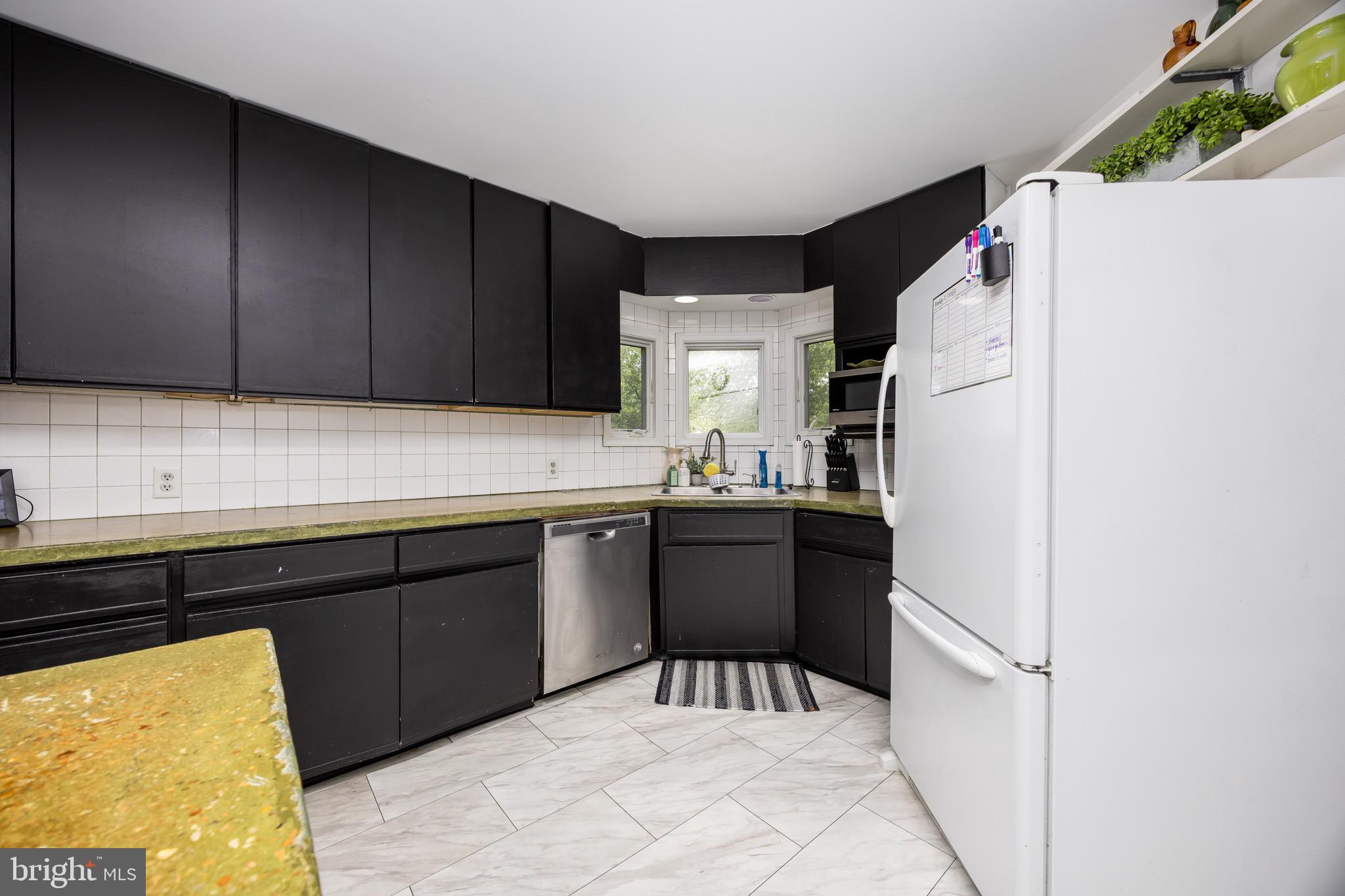 26882 Pratt Road Salisbury, MD 21801 - Photo 20 of 80 a kitchen with a refrigerator and a sink