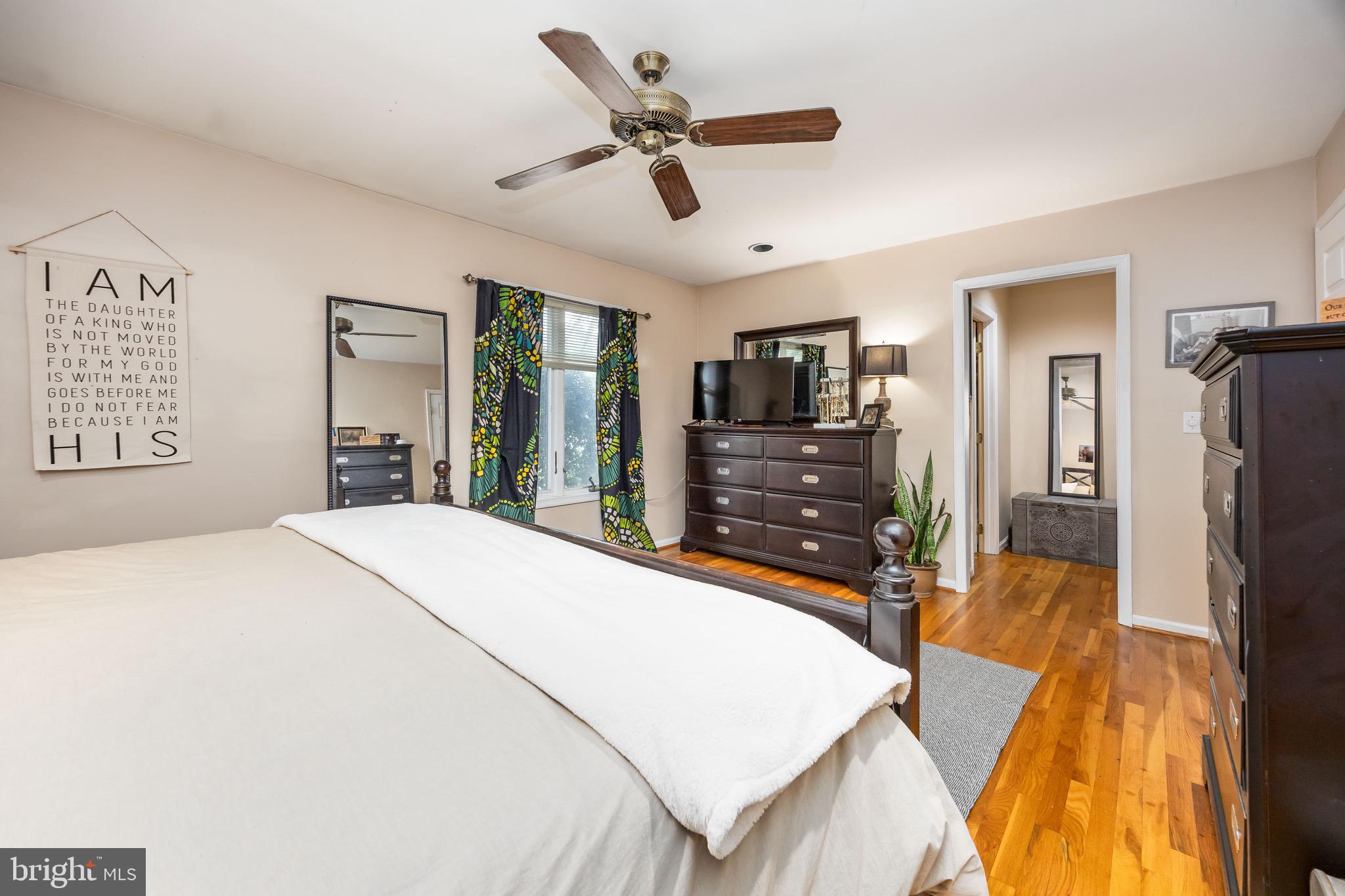 26882 Pratt Road Salisbury, MD 21801 - Photo 34 of 80 a bed room with a bed a flat tv screen and a dresser