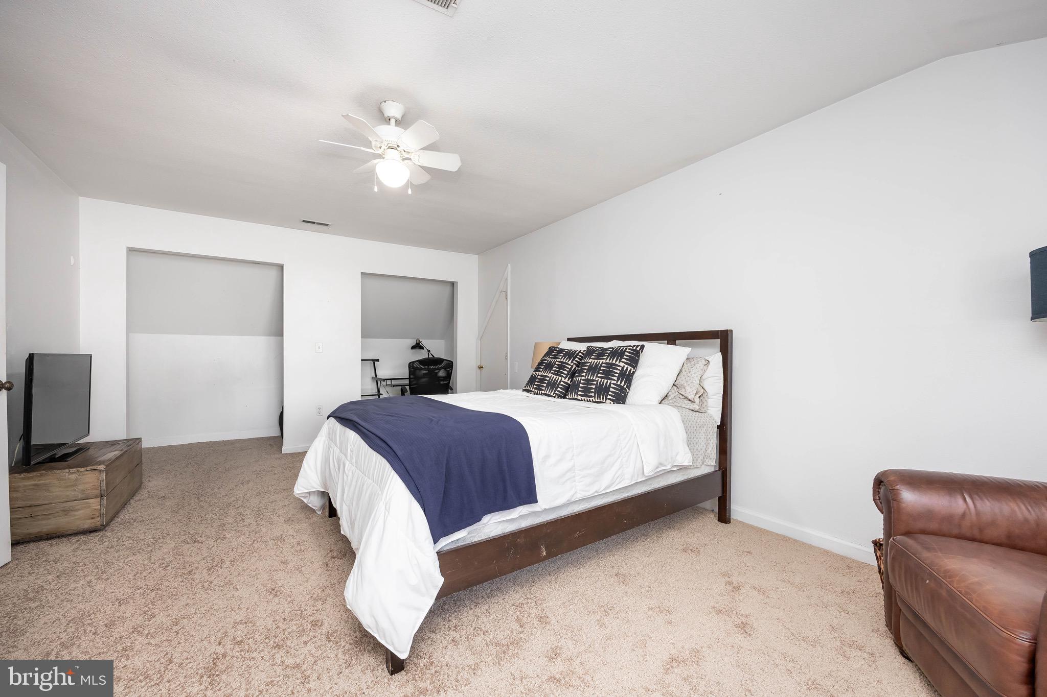 26882 Pratt Road Salisbury, MD 21801 - Photo 54 of 80 a bedroom with a large bed and a couch