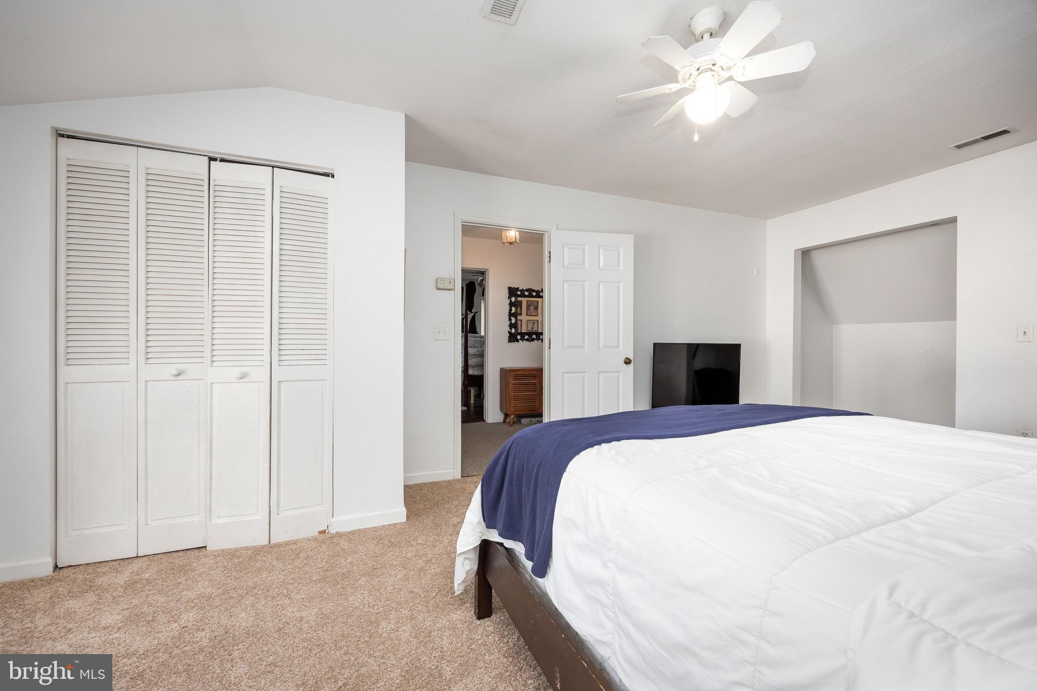 26882 Pratt Road Salisbury, MD 21801 - Photo 56 of 80 a spacious bedroom with a bed and a chandelier