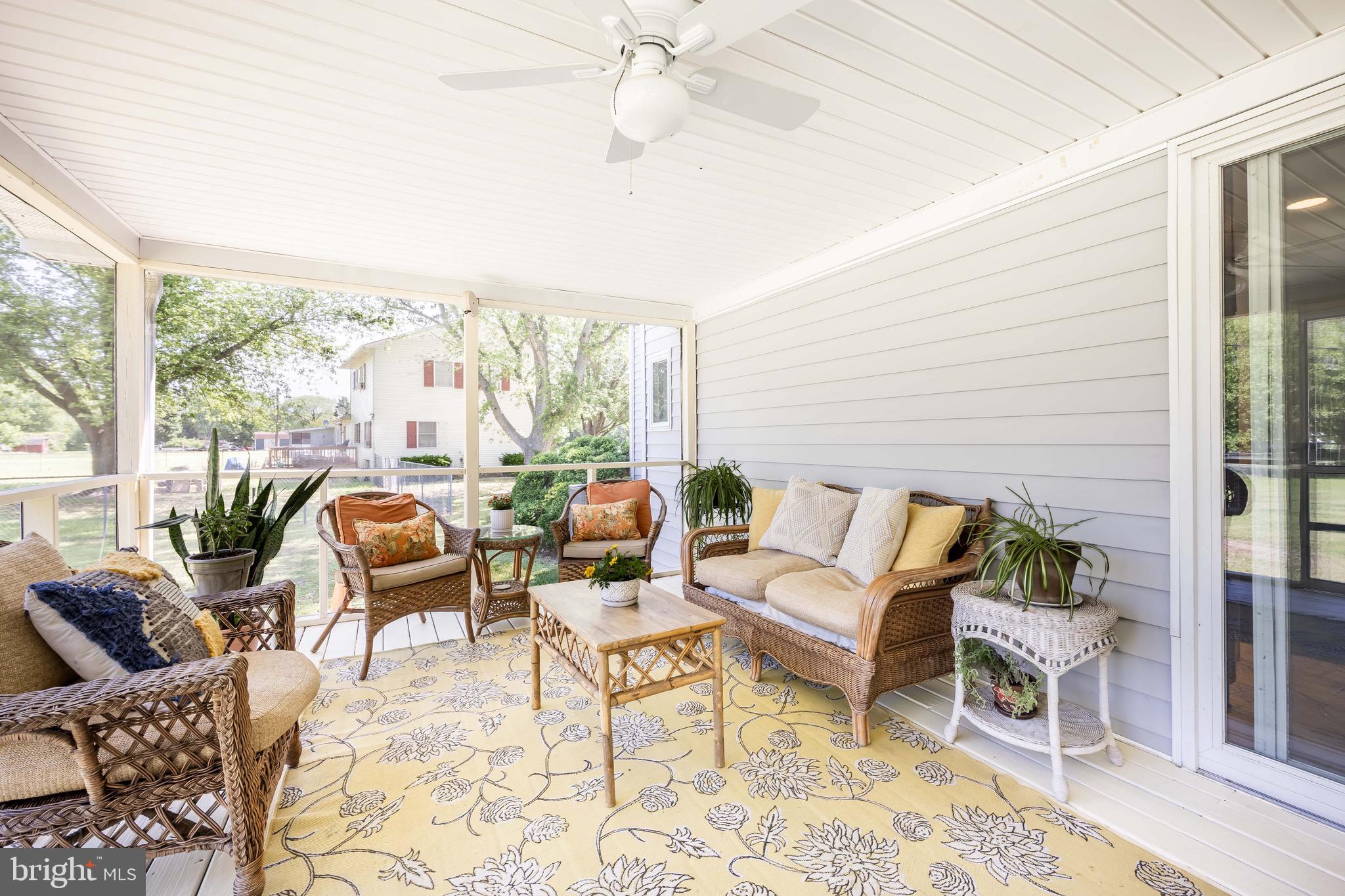 26882 Pratt Road Salisbury, MD 21801 - Photo 59 of 80 a living room with furniture and a floor to ceiling window