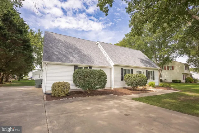 a dining room with furniture a chandelier and wooden floor