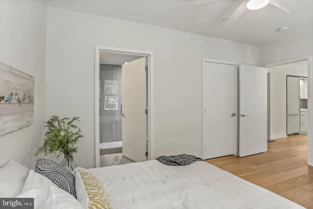 a bedroom with a bed and a potted plant