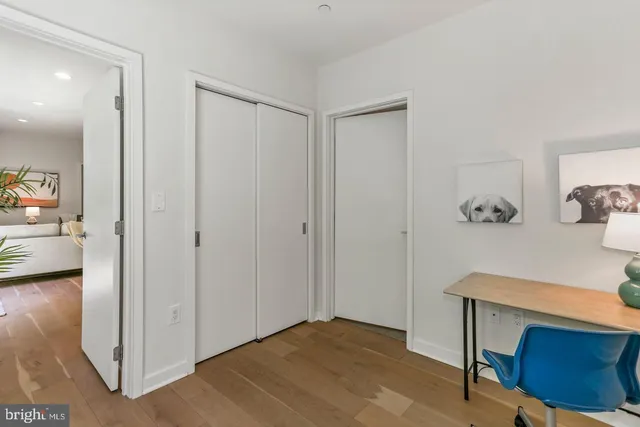 a view of a room that has a table and a chair in it