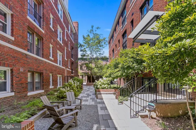 a view of a building with a bench in a patio