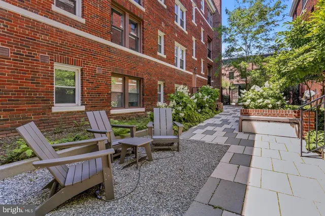 a view of house with backyard and sitting area