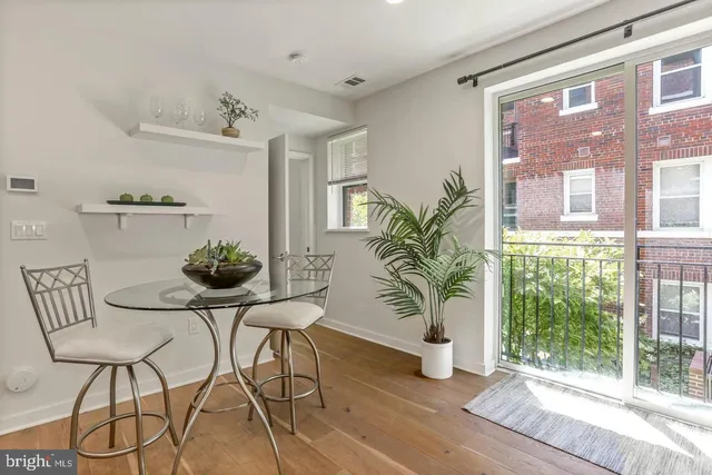 a dining room with furniture and wooden floor