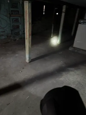 a view of empty room with wooden floor and windows