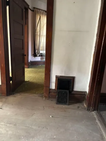 a view of empty room with a fireplace