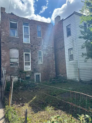 a view of a brick house with a yard