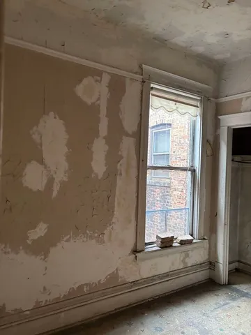 a bathroom with a bathtub and next to a window