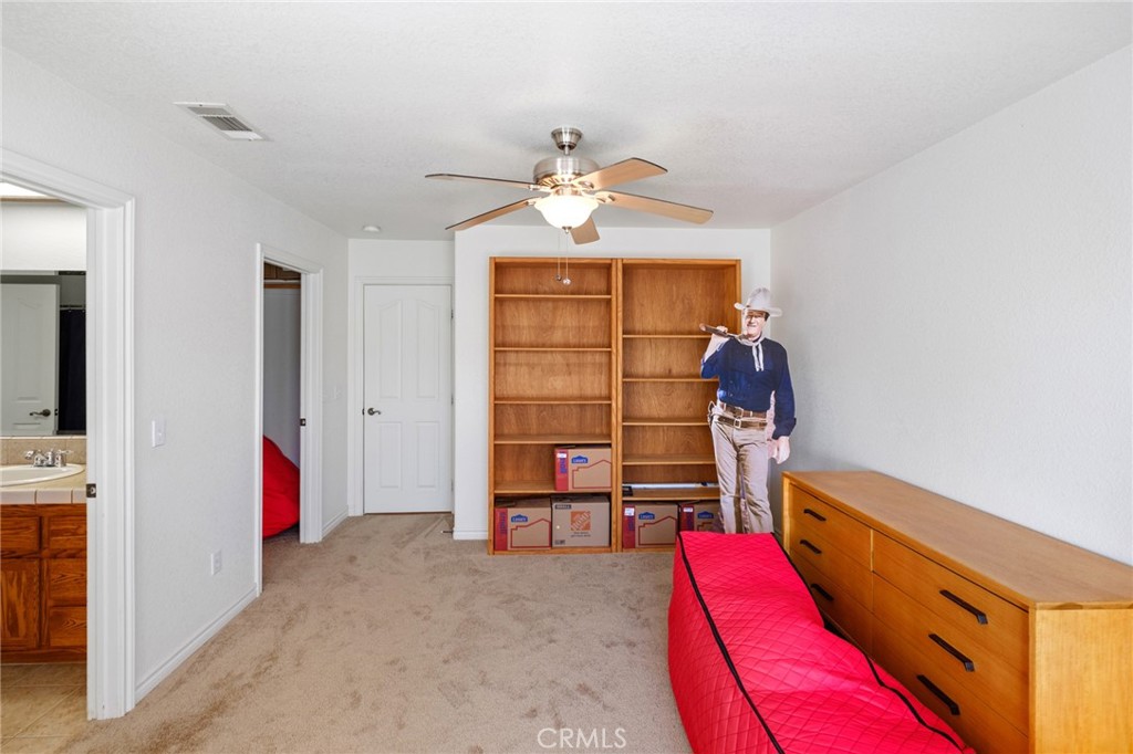 11025 El Esteban Road Phelan, CA 92371 - Photo 27 of 54 a view of walk in closet with clothes and shoes