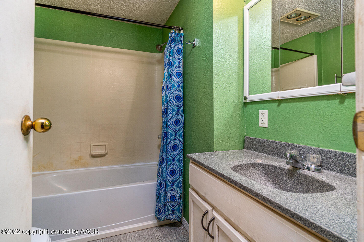 3711 South Harrison Street Amarillo, TX 79110 - Photo 12 of 20 a bathroom with a granite countertop sink and a mirror