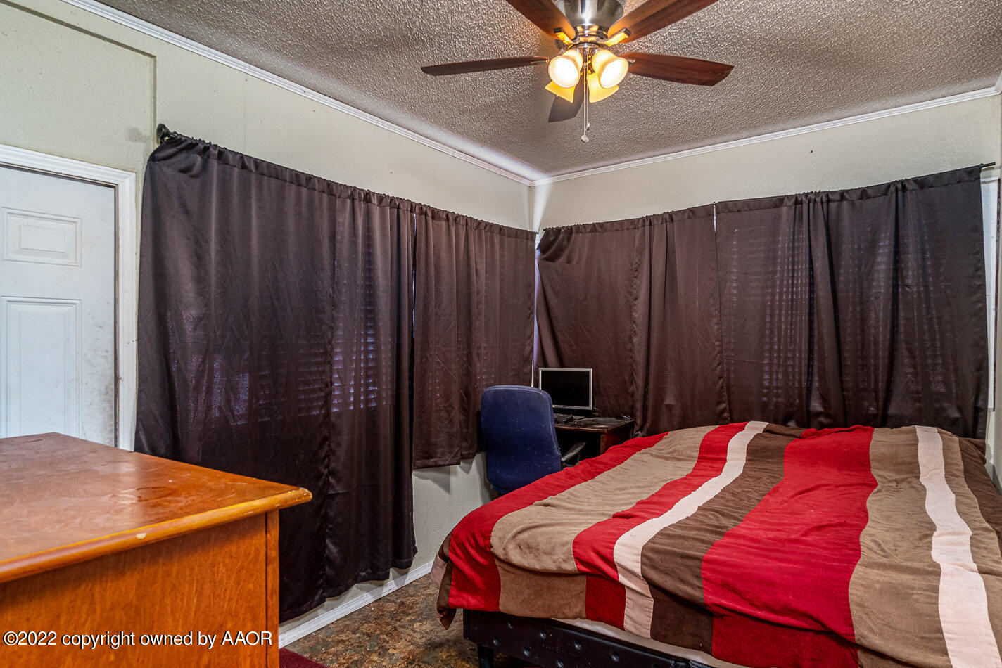 3711 South Harrison Street Amarillo, TX 79110 - Photo 14 of 20 a bedroom with a bed and a chandelier