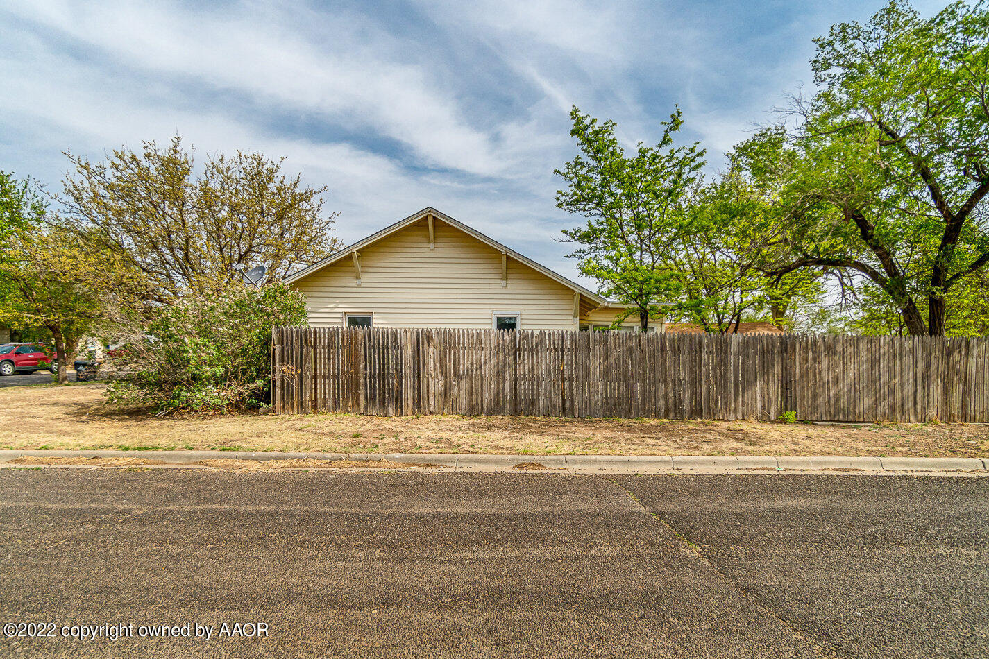 3711 South Harrison Street Amarillo, TX 79110 - Photo 15 of 20 a front view of a house with a yard and garage