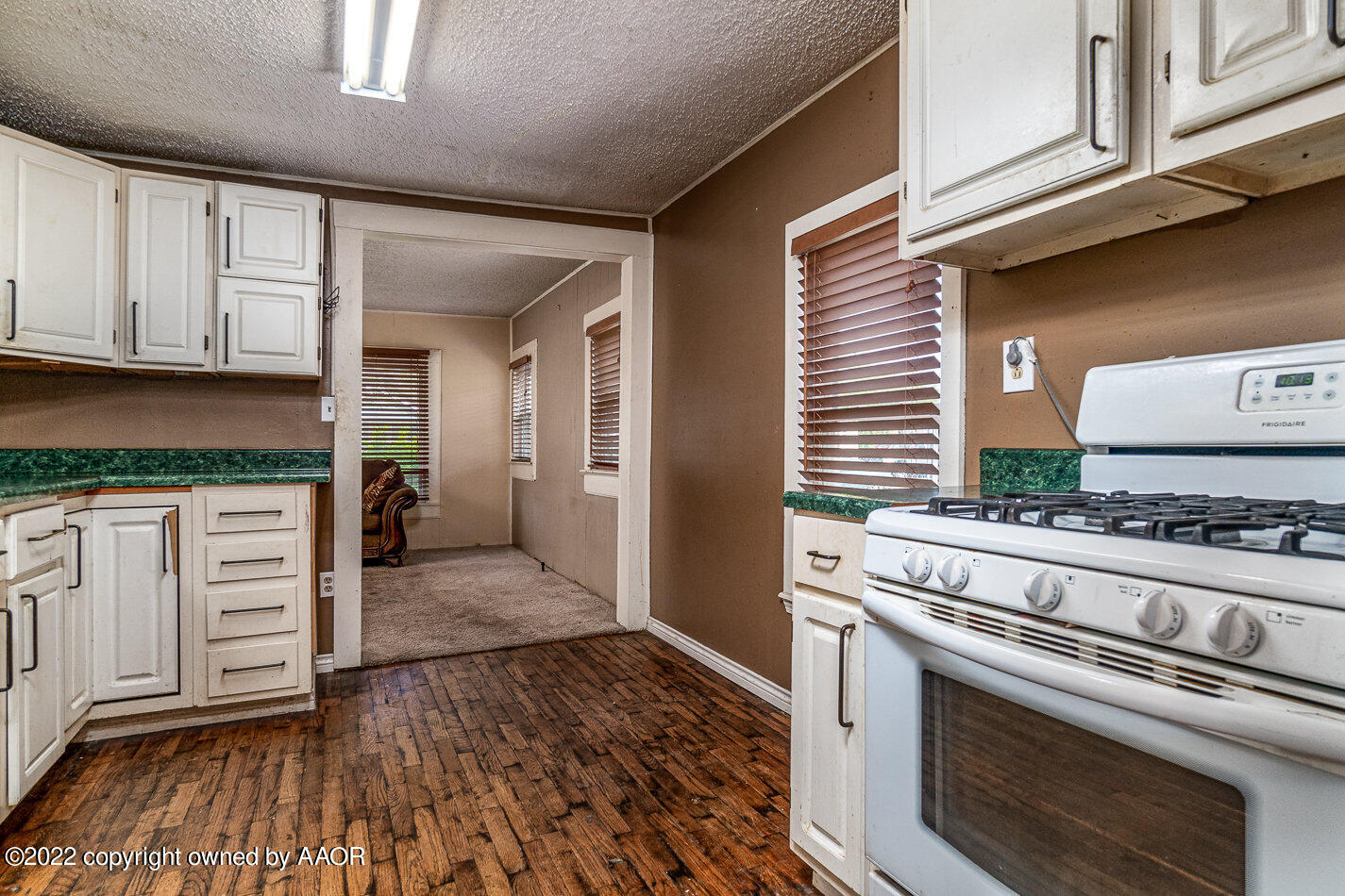 3711 South Harrison Street Amarillo, TX 79110 - Photo 7 of 20 a kitchen with granite countertop a stove and cabinets