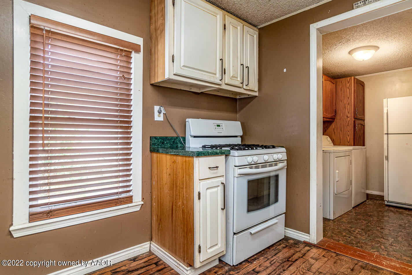 3711 South Harrison Street Amarillo, TX 79110 - Photo 8 of 20 a kitchen with stainless steel appliances granite countertop a stove and a white cabinet