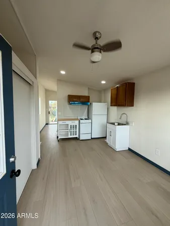 a view of a kitchen with a sink and a refrigerator
