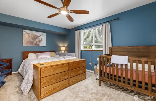 a bedroom with a bed and a large window