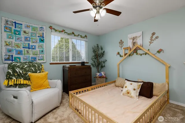 a bedroom with a bed and a wooden floor