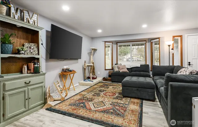 a living room with furniture a flat screen tv and a fireplace