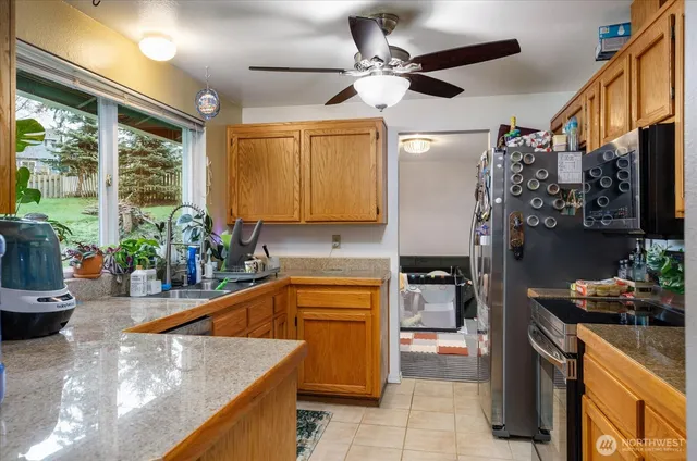 a kitchen with a sink appliances and cabinets