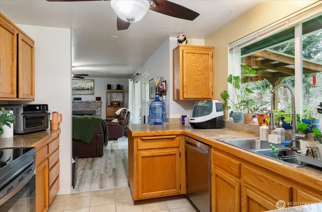 a kitchen with stainless steel appliances granite countertop a sink and a refrigerator