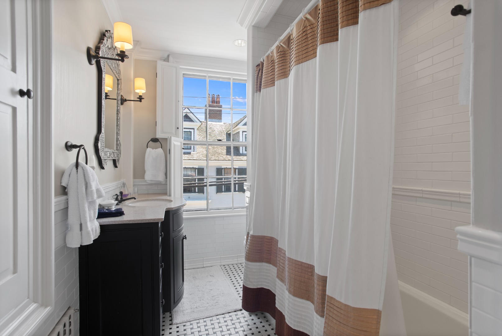 19 Orange Street Nantucket, MA 02554 - Photo 45 of 85 a bathroom with a sink a mirror and a shower