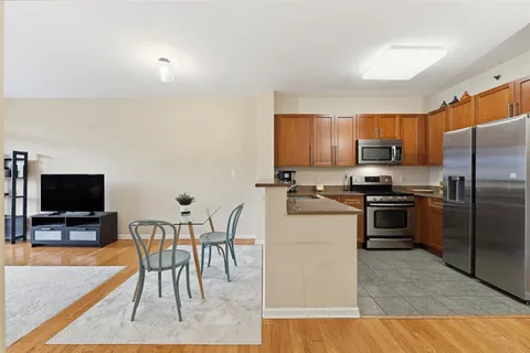 a view of a dining room with furniture and wooden floor