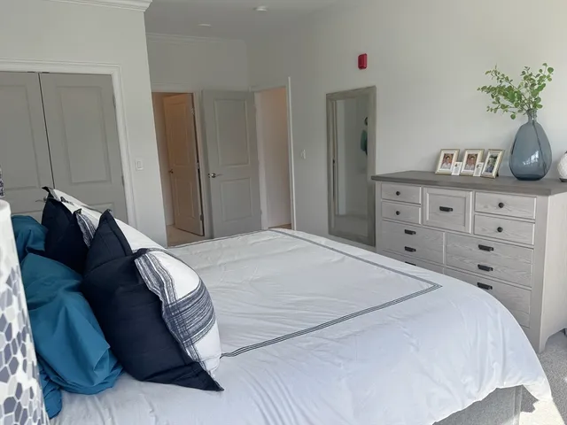a bedroom with a bed and a potted plant