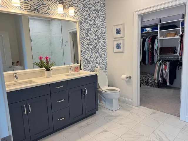 a bathroom with a toilet sink and double