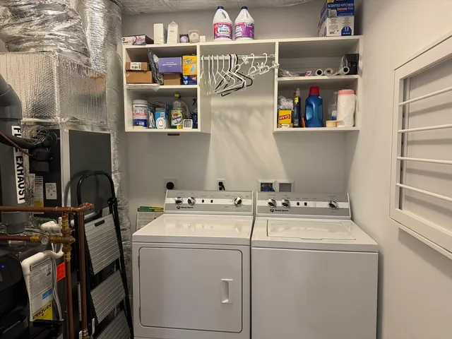 a utility room with dryer washer and other items