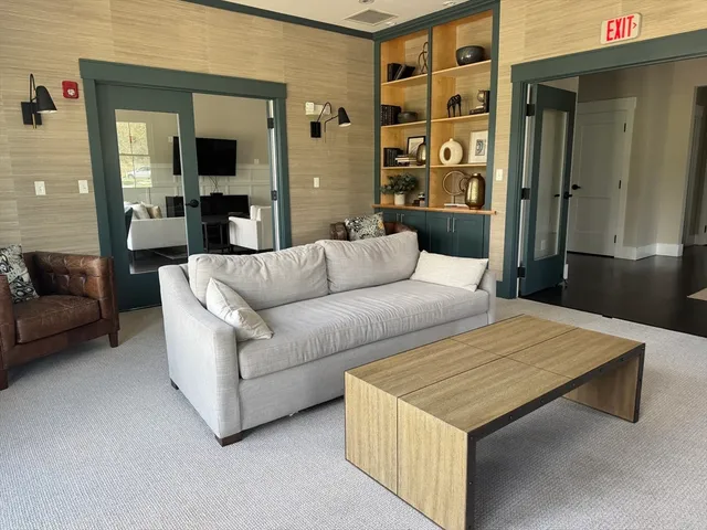 a living room with furniture wooden floor and a flat screen tv